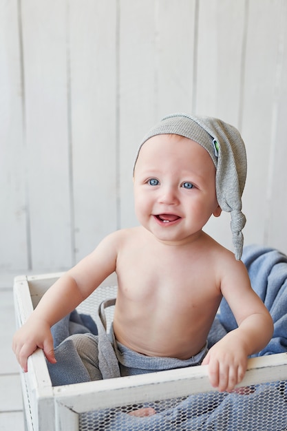 toddler with funny hat in the crib