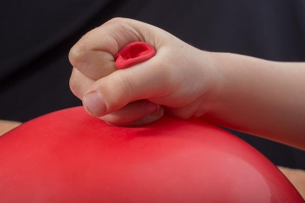 Toddlers hand holding a balloon in hand