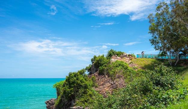 Toeristenpaar dat foto's maakt bij een gezichtspunt op de berg Er is een prachtige blauwe zee op de achtergrond, Noen Nang Phaya Viewpoint, provincie Chanthaburi, Thailand.