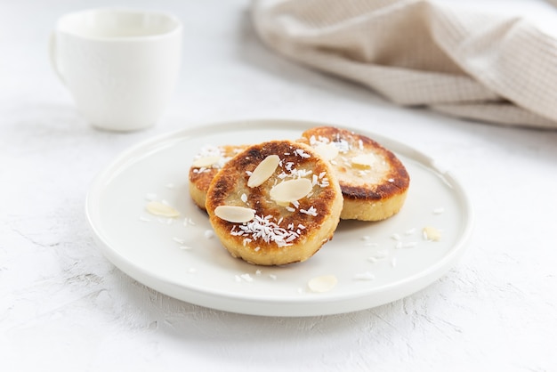 Tofu cheese pancakes on a plate on a light background