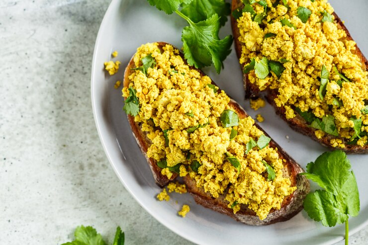 Tofu scramble sandwich on a gray plate. Vegan food concept.