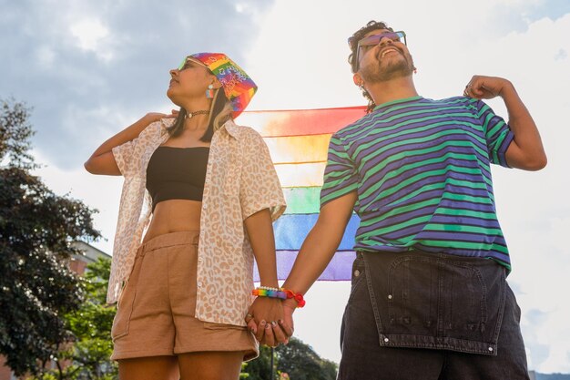 Together in Pride Couple Holding Hands and Rainbow Flag in Park