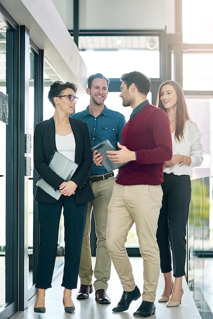 Together they make a great team Shot of a group of colleagues talking together in a large modern office