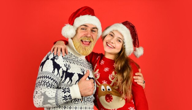 Togetherness winter xmas mood new year is here bearded dad and small girl santa hat funny knitted sweater father and daughter celebrate christmas xmas party together they love family holiday