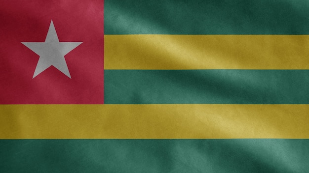 Togolese flag waving in the wind. Togo template blowing, soft and smooth silk. Cloth fabric texture ensign background.