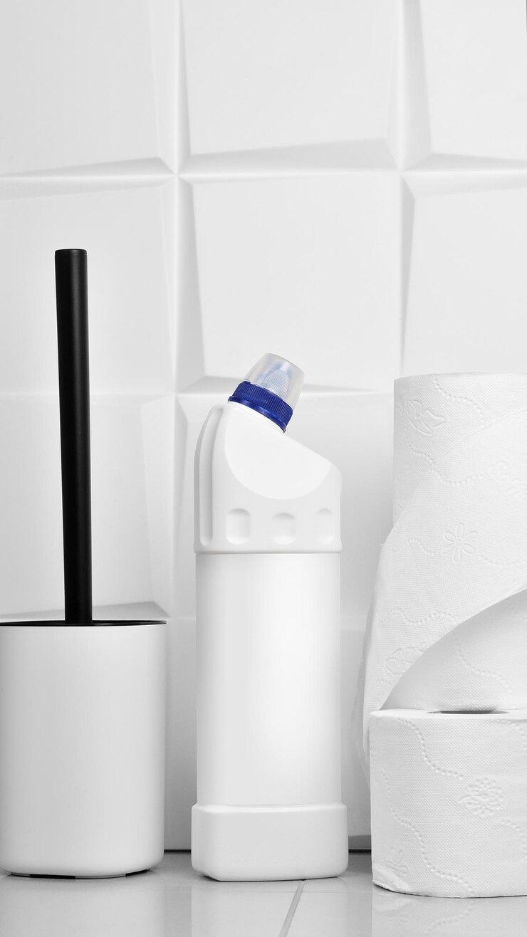 Photo toilet cleaner bottle with liquid in bathroom