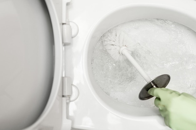 Toilet cleaners hand washing the toilet