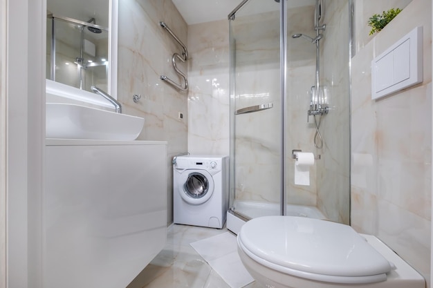 toilet and detail of a corner shower cabin with wall mount shower attachment