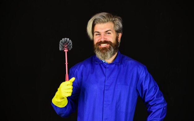 Toilet disinfection. Man protective rubber gloves. Clean home. Destroy microorganisms. Disinfection concept. Bearded cleaner in blue uniform. Spring cleaning. Hipster clean house. Virus and microbe.