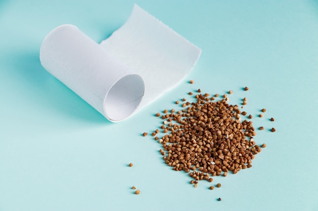 Toilet paper and buckwheat on a blue background. Concept panic buying food at a quarantine.