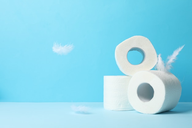 Photo toilet paper and feathers on blue