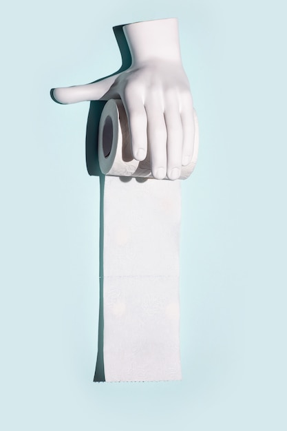 Toilet paper and hand. A concept on the theme of coronavirus