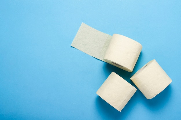 Toilet paper rolls on a blue