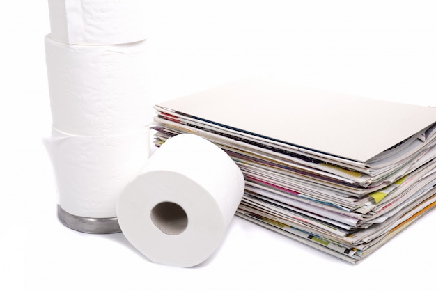 Toilet paper and stack of magazines