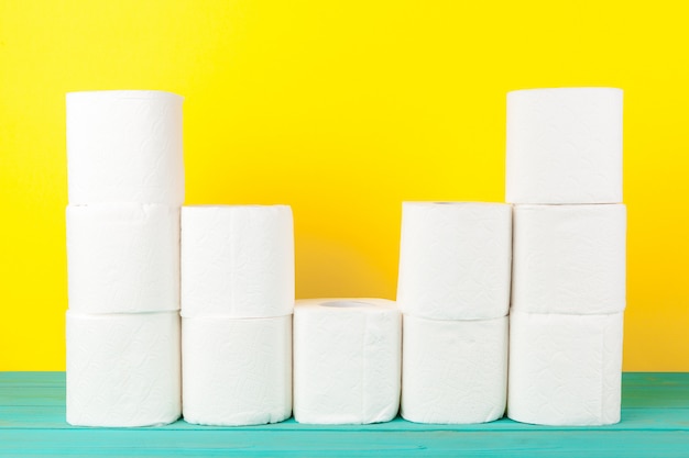 Toilet paper stacks  on bright yellow 