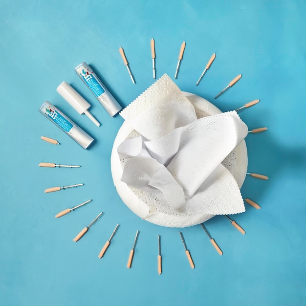 Photo toilet paper with nails on blue background hemorrhoidal suppositories and toilet paper with nails