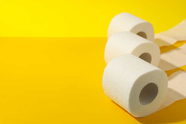 Toilet paper on yellow table