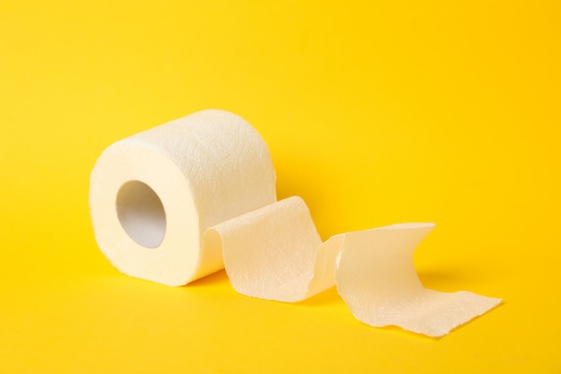 Toilet paper on yellow table