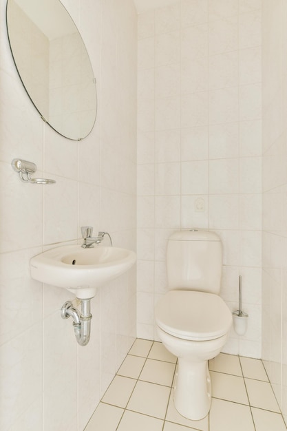 Toilet with white tiled walls