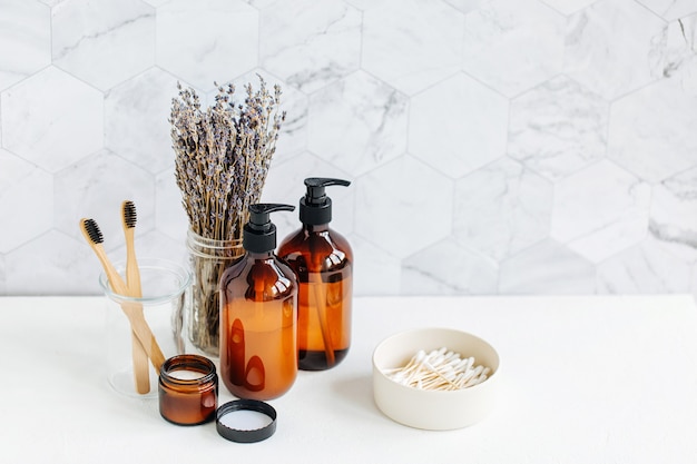 Toiletry Set with lavender. Soap and shampoo bottles on white table in bathroom background.