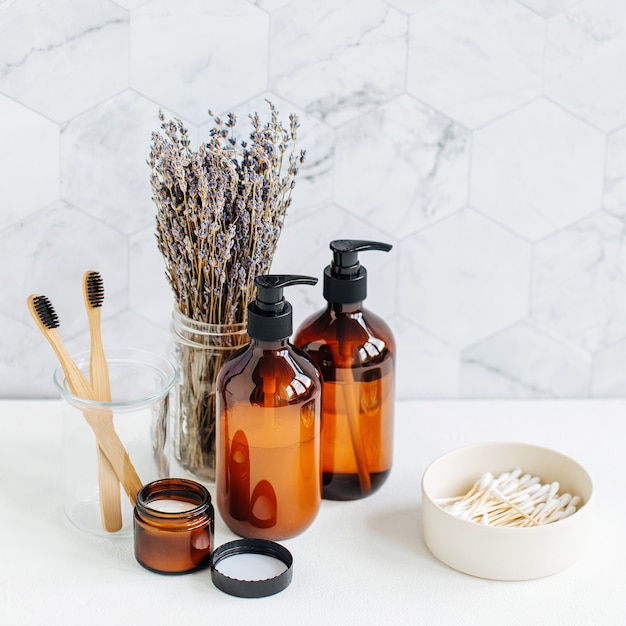 Toiletry Set with lavender. Soap and shampoo bottles on white table in bathroom background.