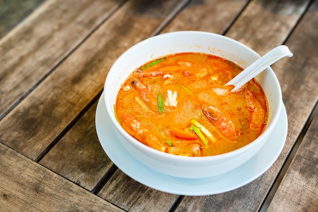 Tom Yam Kung, Thai cuisine. on a wooden table.