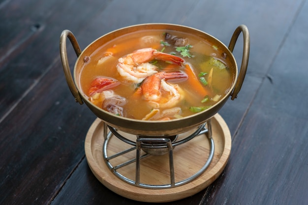 Tom yam kung or Tom yum, Tom yam is a spicy clear soup with shrimps, close up. Popular food in Thailand, thai cuisine