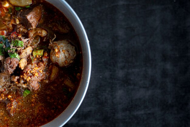 Tom Yum Beef Noodle on the table is not black.