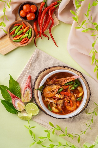 Tom yum or tom yam is a type of hot and sour Thai soup usually cooked with shrimp prawn