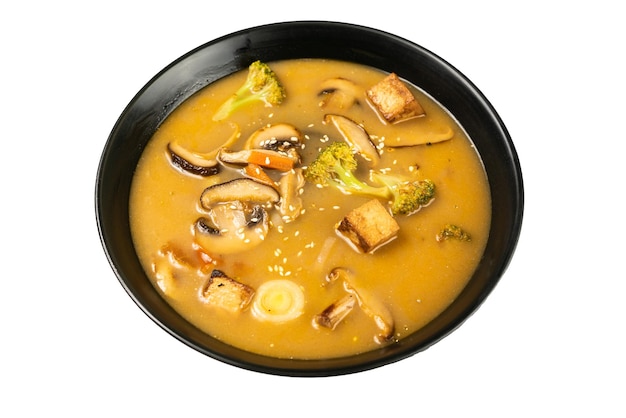 Tom yum vegetarian soup in a black dish on a white background a Thai dish