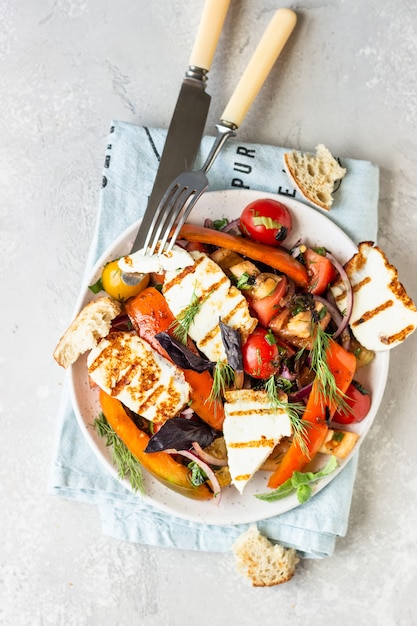 Tomato, baked pepper and onion salad with grilled cheese 