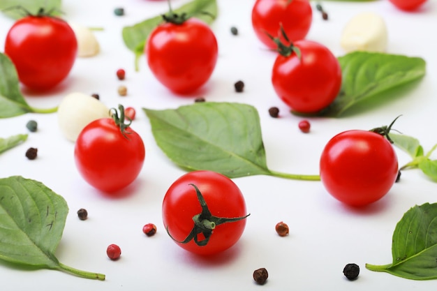 Tomato basil spices pepper garlic Vegan diet food creative cherry tomato composition isolated on white