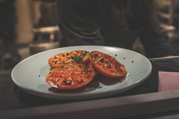 Tomato dish on a black plate.