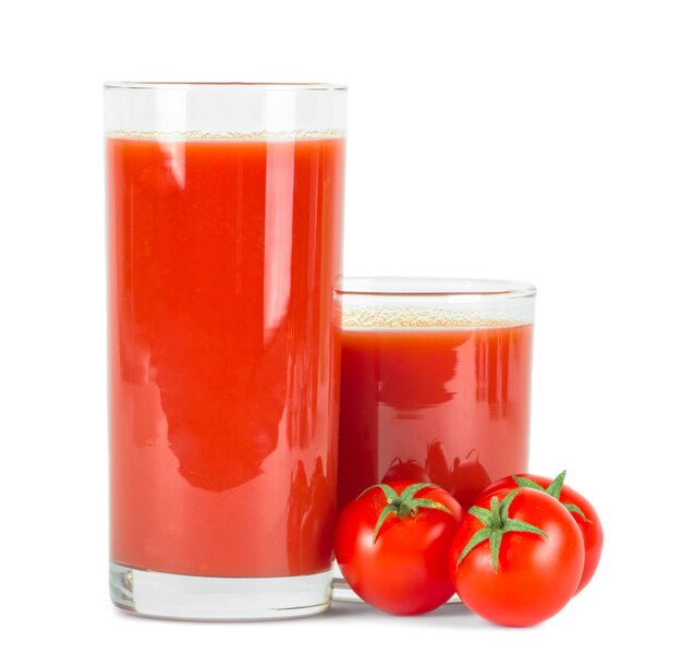 Tomato juice in glass and fresh tomatoes .