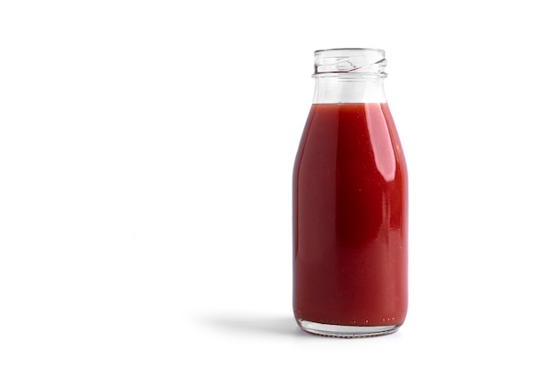 Tomato juice in glass isolated on white.