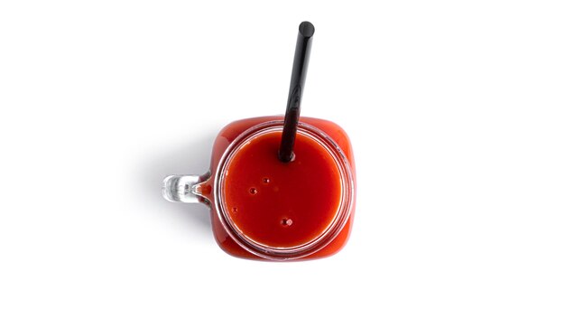 Tomato juice in glass on white