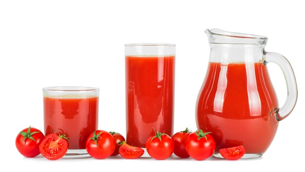 Tomato juice in glasses and fresh tomatoes