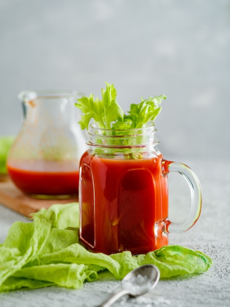 Tomato juice in mason jar with celery and salt,