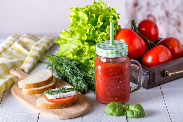 Tomato juice in a transparent jar with spinach