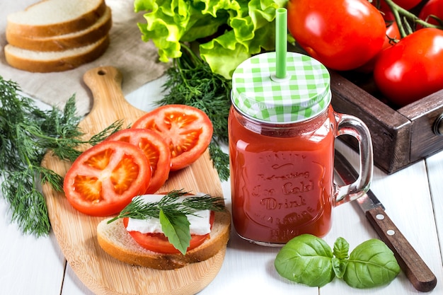 Tomato juice in a transparent jar with spinach