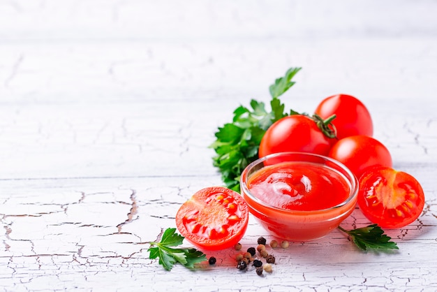 Tomato ketchup sauce on wooden background