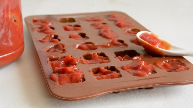 Tomato paste cubes in the plastic shape Life hacks simple way to store vegetables