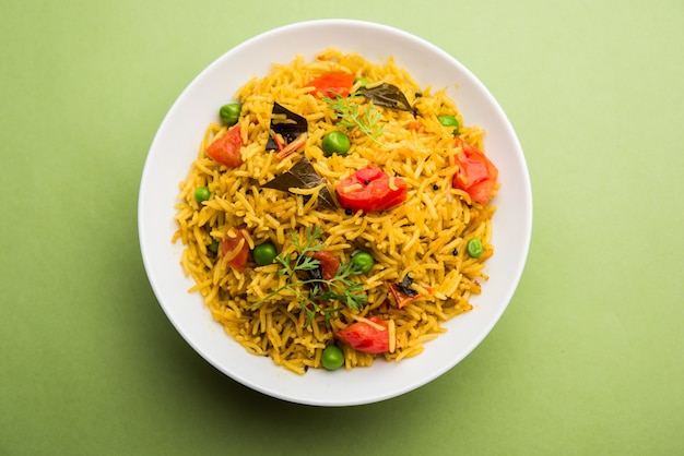 Tomato Rice also known as Tamatar Pilaf or pulav made using basmati rice, served in a bowl. selective focus