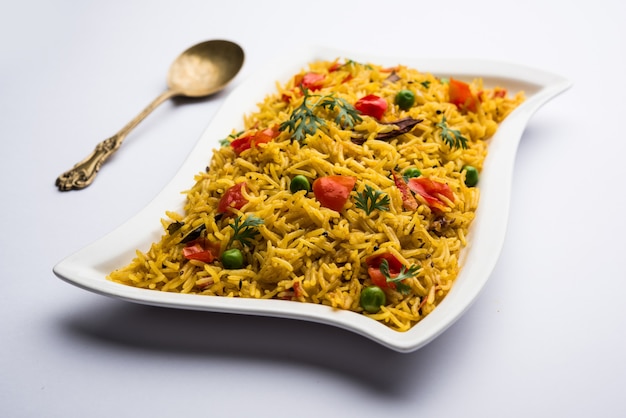 Tomato Rice also known as Tamatar Pilaf or pulav made using basmati rice, served in a bowl. selective focus