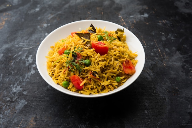 Tomato Rice also known as Tamatar Pilaf or pulav made using basmati rice, served in a bowl. selective focus