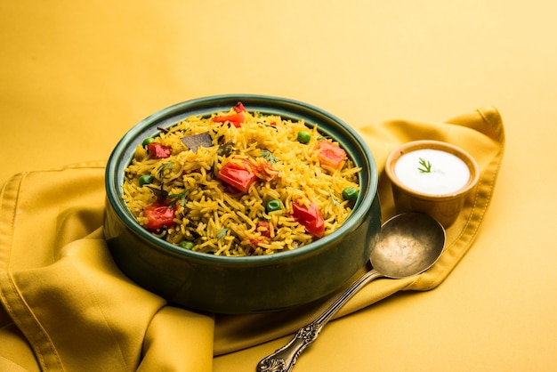 Tomato Rice also known as Tamatar Pilaf or pulav made using basmati rice, served in a bowl. selective focus