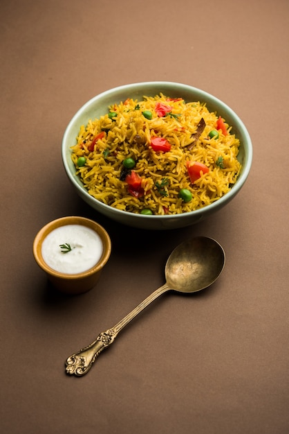 Tomato Rice also known as Tamatar Pilaf or pulav made using basmati rice, served in a bowl. selective focus