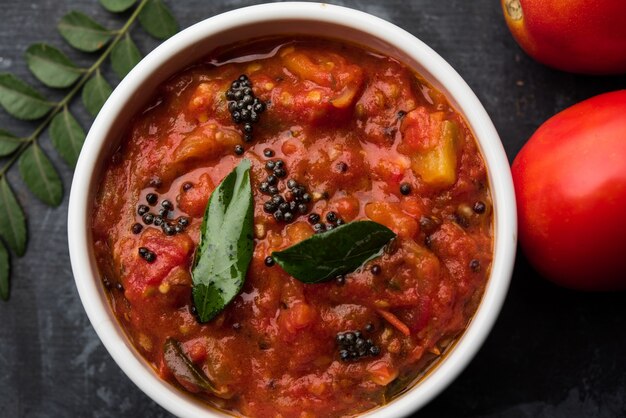 Tomato sabzi or tamatar chutney or sauce, served in a bowl. selective focus