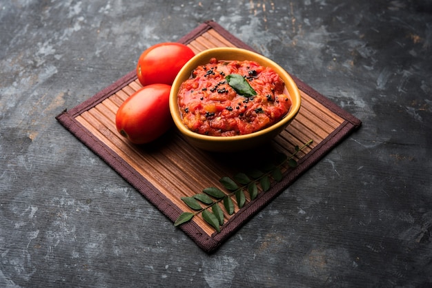 Tomato sabzi or tamatar chutney or sauce, served in a bowl. selective focus