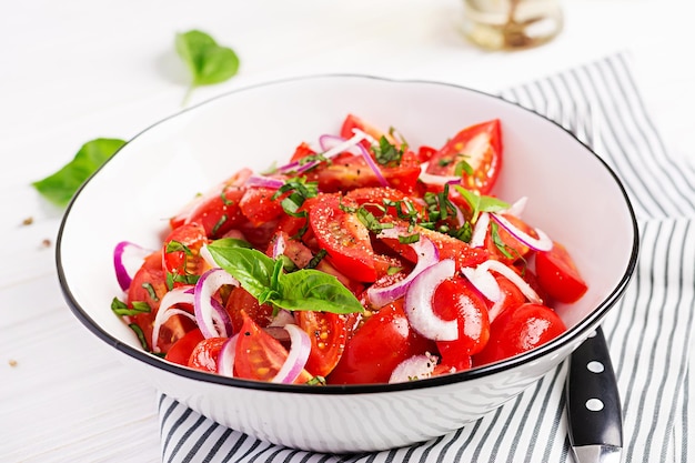 Tomato salad with basil and red onions Homemade food Concept healthy meal Vegan cuisine